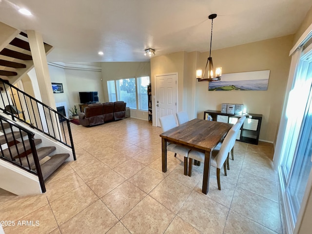 dining room featuring light tile patterned floors, recessed lighting, stairs, and an inviting chandelier