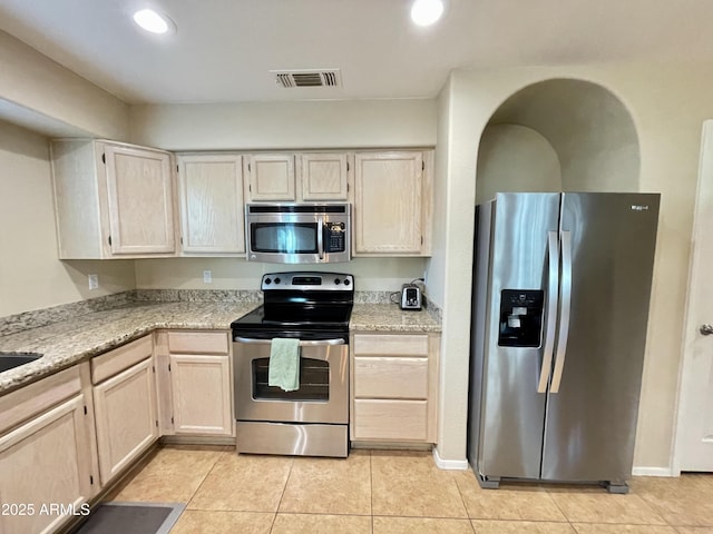 kitchen featuring visible vents, recessed lighting, stainless steel appliances, light tile patterned flooring, and light stone countertops