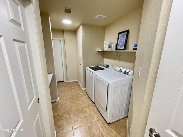 laundry room with light tile patterned floors, laundry area, washer and dryer, and visible vents