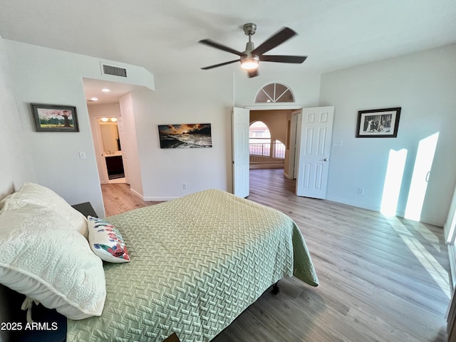 bedroom featuring visible vents, ceiling fan, and wood finished floors