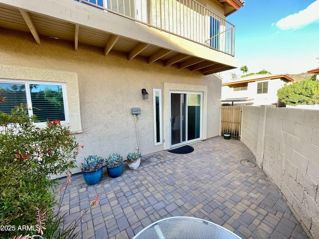 view of patio / terrace featuring a balcony and fence