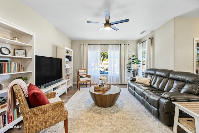 living room with hardwood / wood-style floors and ceiling fan