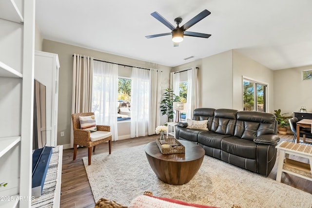 living room featuring dark hardwood / wood-style floors and ceiling fan