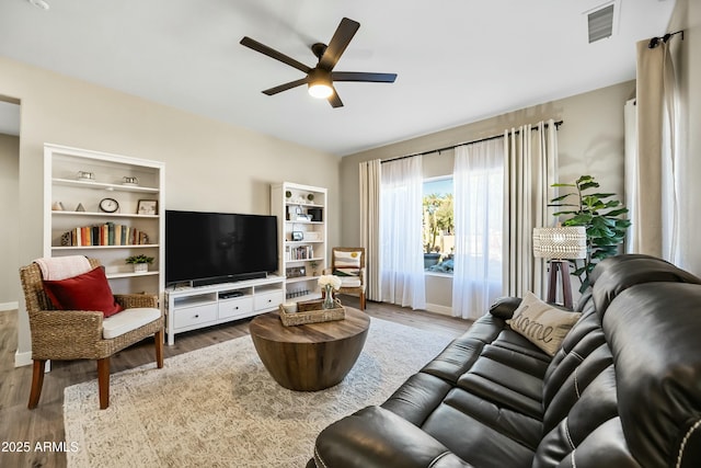 living room with ceiling fan and hardwood / wood-style floors