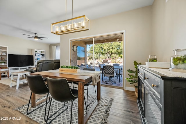 dining area with dark hardwood / wood-style flooring and ceiling fan