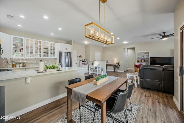 dining room with wood-type flooring and ceiling fan