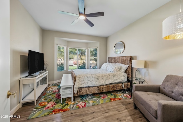 bedroom with hardwood / wood-style flooring and ceiling fan