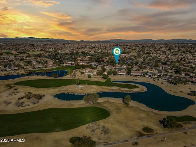 aerial view at dusk featuring a mountain view