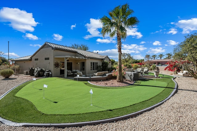 back of property featuring outdoor lounge area and a patio area