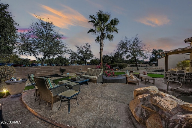 patio terrace at dusk featuring an outdoor living space