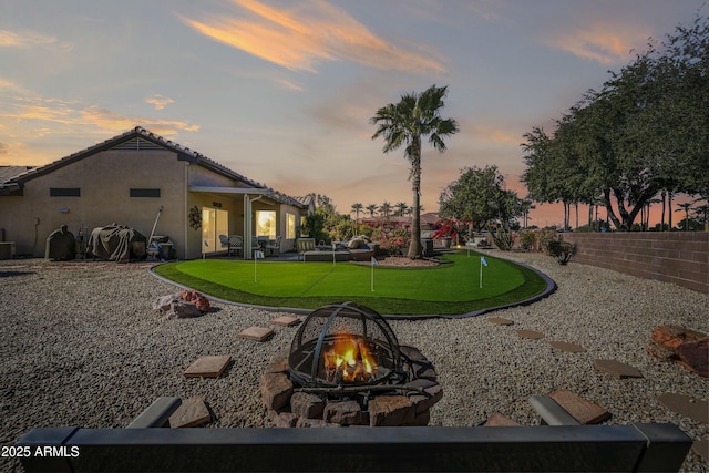 yard at dusk with a fire pit