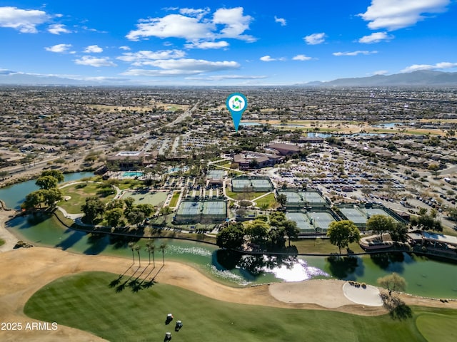 birds eye view of property with a water and mountain view