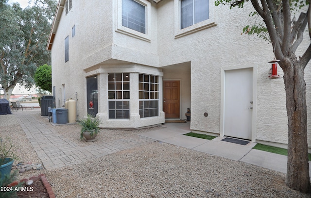 rear view of property with central AC and a patio area