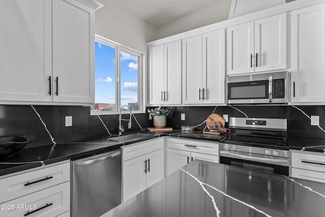 kitchen with white cabinets, appliances with stainless steel finishes, and sink