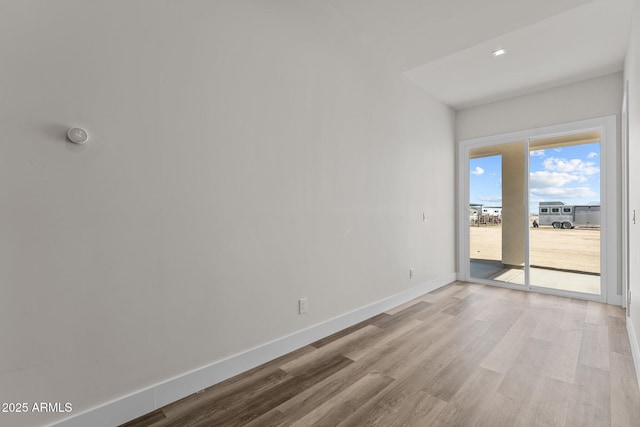 spare room featuring wood-type flooring