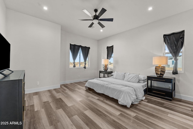 bedroom with light hardwood / wood-style floors and ceiling fan