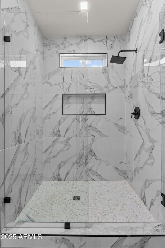 bathroom with a shower with shower door