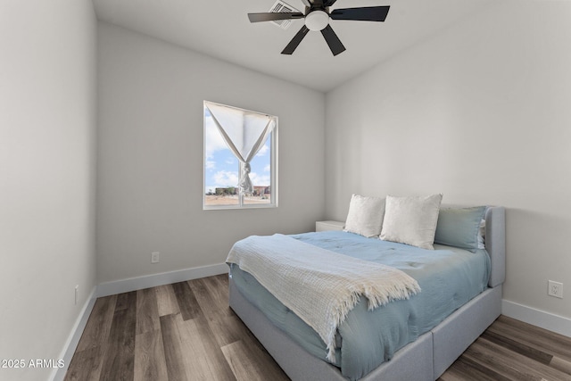 bedroom with ceiling fan and dark hardwood / wood-style flooring