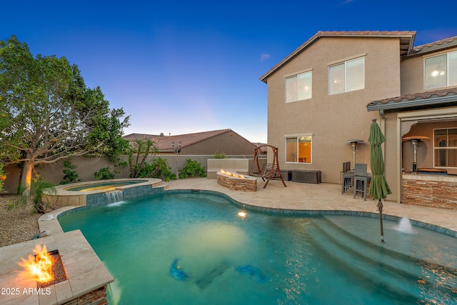26036 N 85th Dr, Peoria, AZ 85383 - pool at dusk featuring an outdoor fire pit, a patio, and a pool with connected hot tub