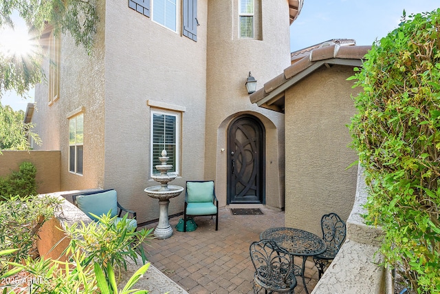26036 N 85th Dr, Peoria, AZ 85383 - view of exterior entry with stucco siding and a patio area