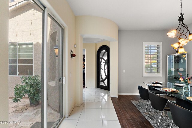26036 N 85th Dr, Peoria, AZ 85383 - foyer featuring arched walkways, a chandelier, and baseboards