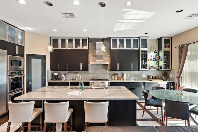 26036 N 85th Dr, Peoria, AZ 85383 - kitchen with wall chimney exhaust hood, decorative backsplash, stainless steel appliances, hanging light fixtures, and recessed lighting
