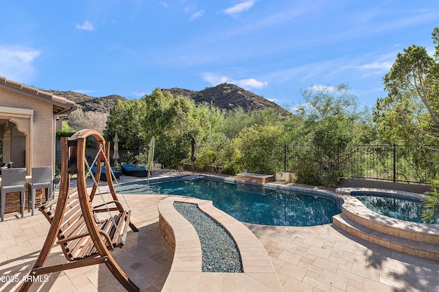 26036 N 85th Dr, Peoria, AZ 85383 - view of swimming pool featuring a mountain view, a fenced backyard, a patio, and a pool with connected hot tub