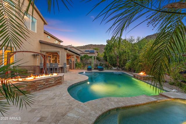 26036 N 85th Dr, Peoria, AZ 85383 - view of swimming pool featuring an outdoor fire pit, a patio area, an in-ground hot tub, and a mountain view