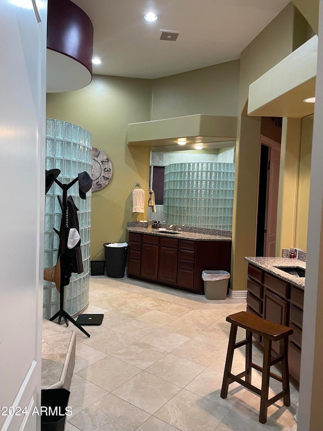 bathroom with tile flooring and vanity