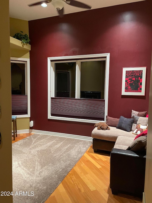 living room with ceiling fan and hardwood / wood-style flooring