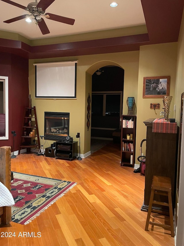 living room with ceiling fan and light wood-type flooring