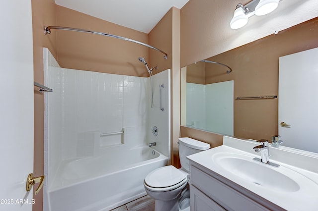 bathroom featuring toilet, vanity, and bathtub / shower combination