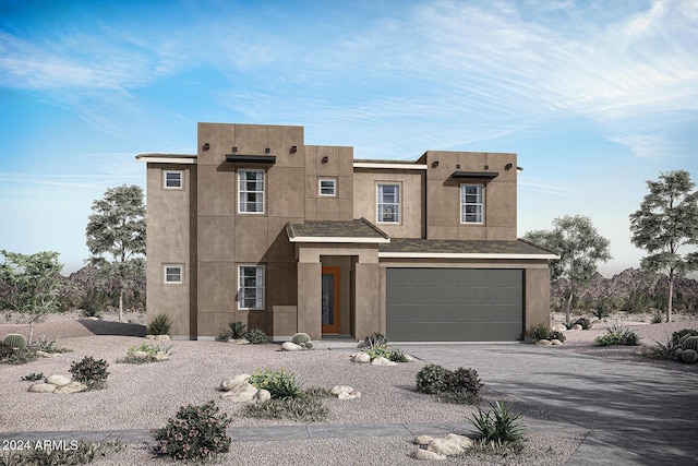 pueblo-style house featuring a garage