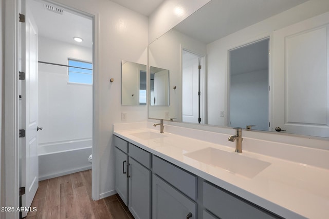 full bathroom with toilet, bathing tub / shower combination, and vanity