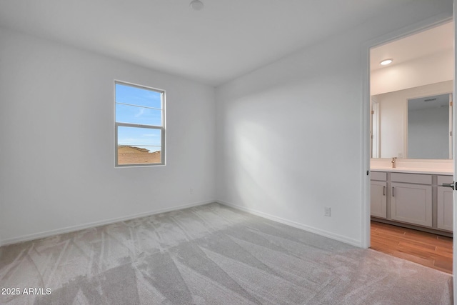 carpeted spare room with sink