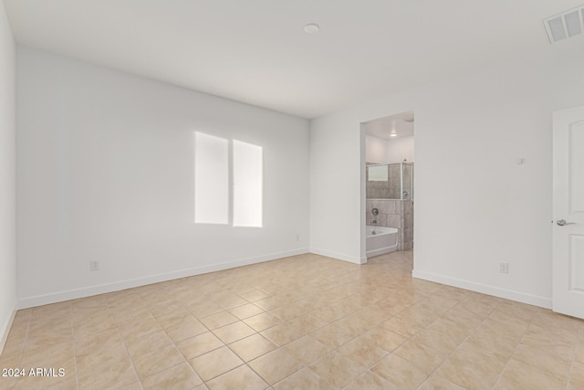 unfurnished room with light tile patterned flooring