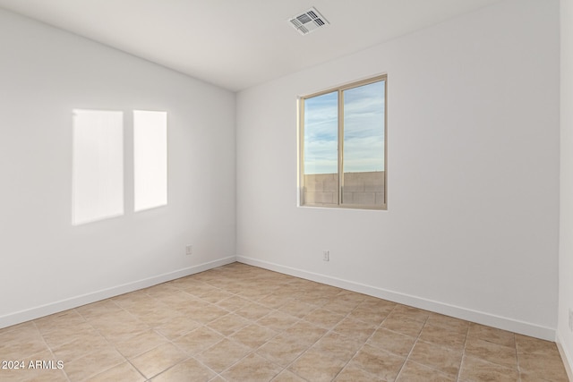 unfurnished room with light tile patterned flooring