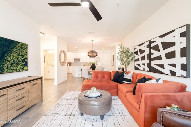 2511 W Queen Creek Rd Unit 325, Chandler, AZ 85248 - living room featuring a ceiling fan and light wood-type flooring
