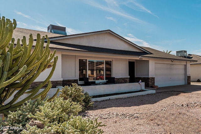 view of front facade with central AC and a garage