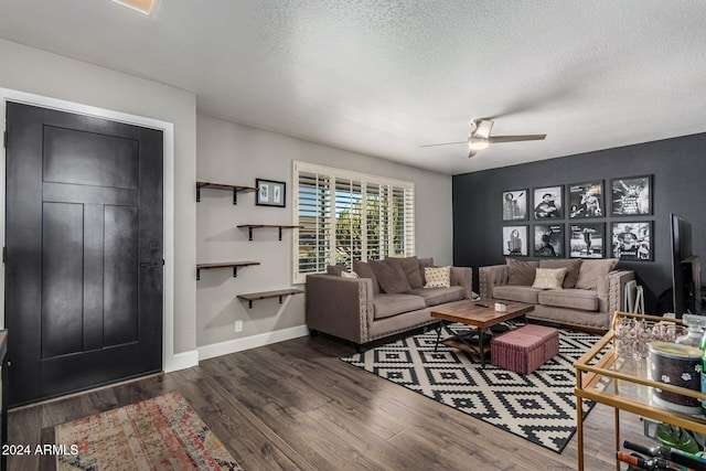 living room featuring a textured ceiling, ceiling fan, and dark hardwood / wood-style flooring