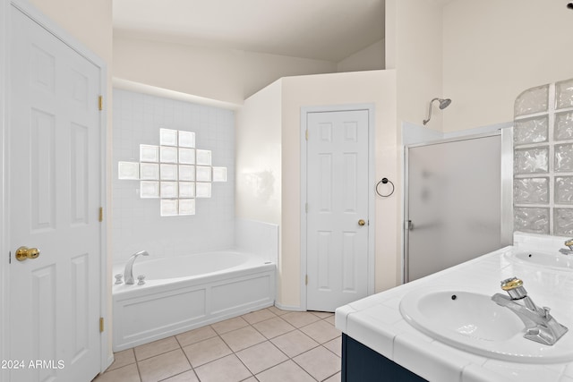 bathroom with lofted ceiling, vanity, tile patterned flooring, and plus walk in shower