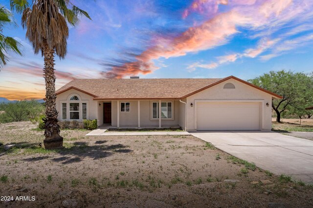 ranch-style home featuring a garage