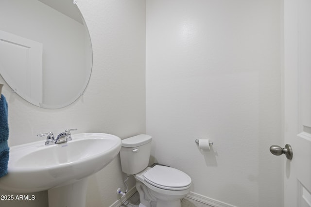 bathroom featuring toilet and sink