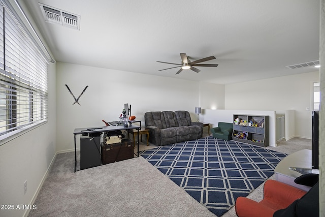 carpeted living room featuring ceiling fan