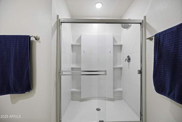 bathroom with a shower with shower door