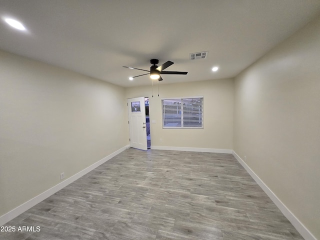 empty room with light hardwood / wood-style flooring and ceiling fan