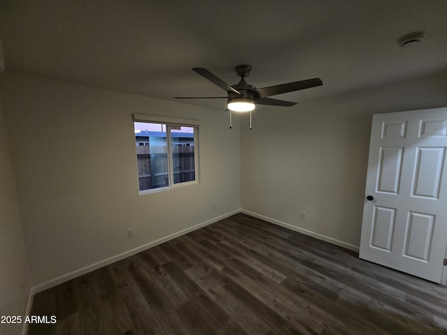 unfurnished room with ceiling fan and dark hardwood / wood-style flooring