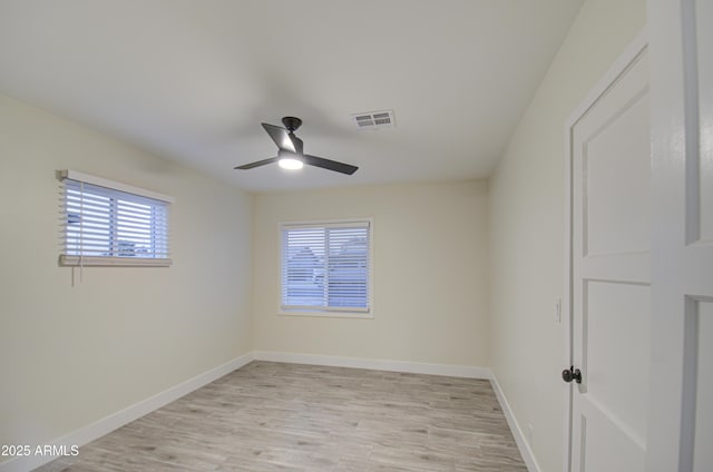 empty room with ceiling fan and light hardwood / wood-style floors