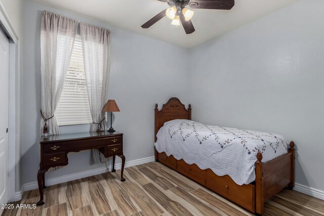 bedroom with ceiling fan and wood-type flooring