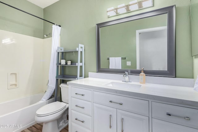 full bathroom featuring hardwood / wood-style flooring, toilet, vanity, and shower / bath combination with curtain